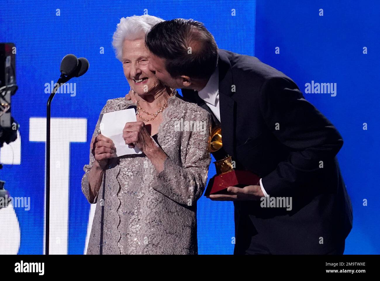 Angela Alvarez, left, receives a kiss on the cheek from grandson Carlos