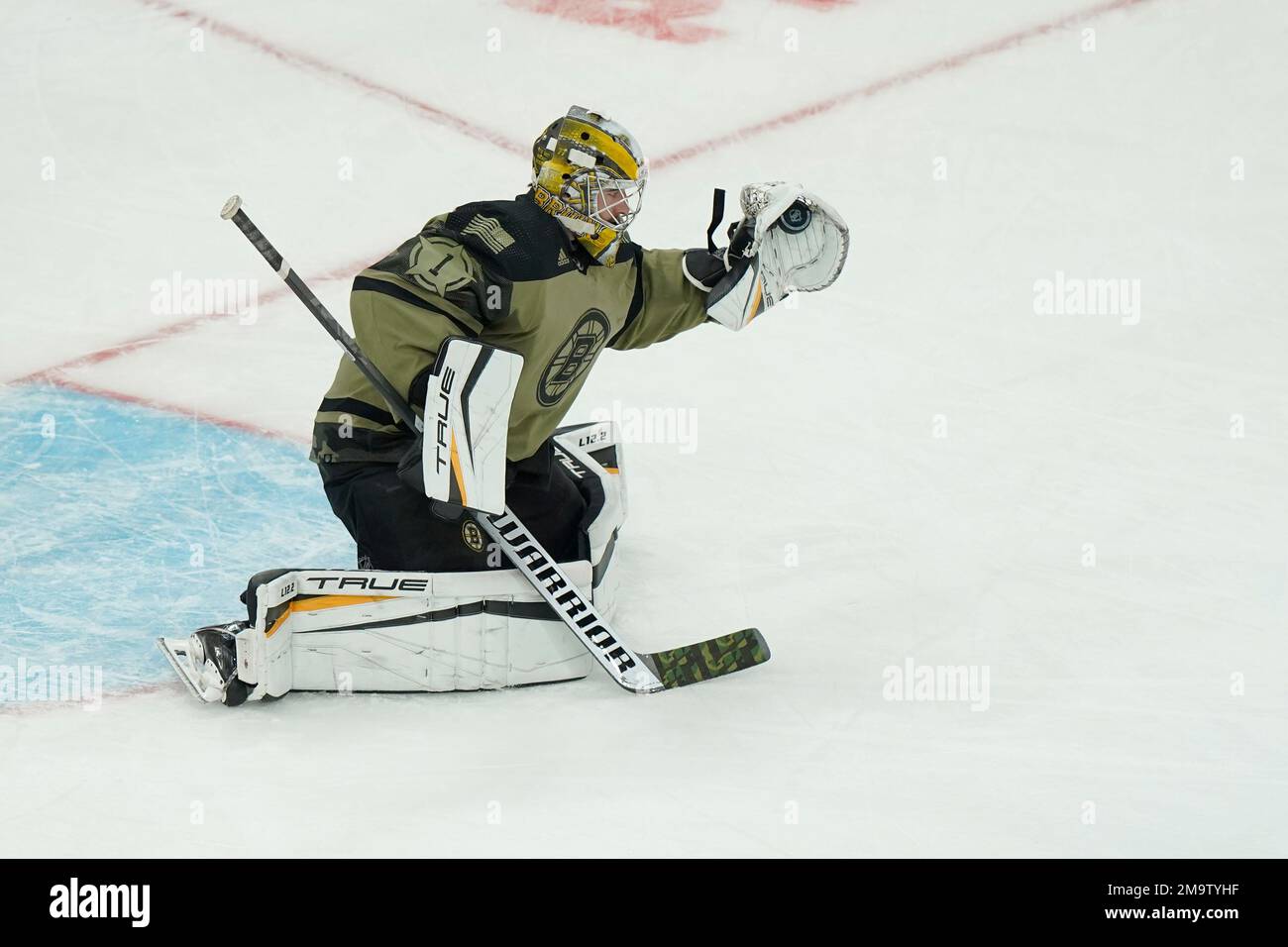 Boston Bruins goaltender Jeremy Swayman (1) wears a green jersey as part of  the team's Salute to Service to honor members of the military while warming  up prior to an NHL hockey