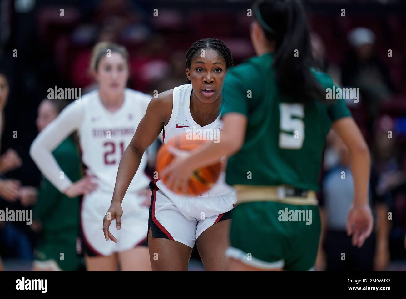 Stanford guard Agnes Emma-Nnopu, middle, defends Cal Poly guard