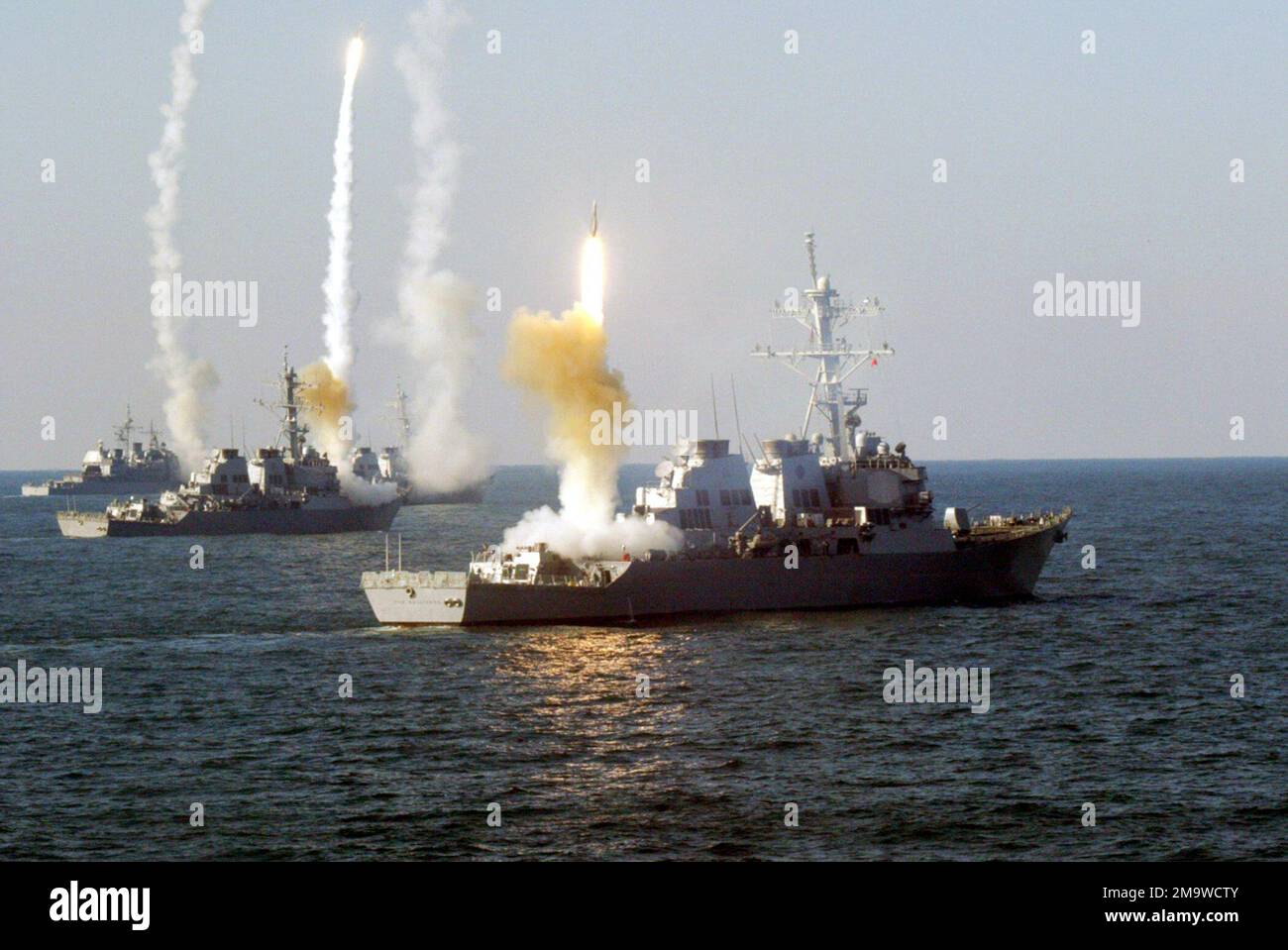 US Navy (USN) Ships launch a coordinated volley of SM-2MR Block II Standard missiles, during a Vandel Exercise (VANDALEX), designed to intercept hostile missiles with ship based missiles during an attack. Remote-controlled drones were used to simulate the hostile missiles. Pictured foreground-to-background are the USN ARLEIGH BURKE CLASS: (Flight I) Guided Missile Destroyer (Aegis), USS THE SULLIVANS (DDG 68), the USS CARNEY (DDG 64), the USN ARLEIGH BURKE CLASS: (Flight IIA) Guided Missile Destroyer (Aegis), USS ROOSEVELT (DDG 80), and the USN TICONDEROGA CLASS: Guided Missile Cruiser (Aegis) Stock Photo
