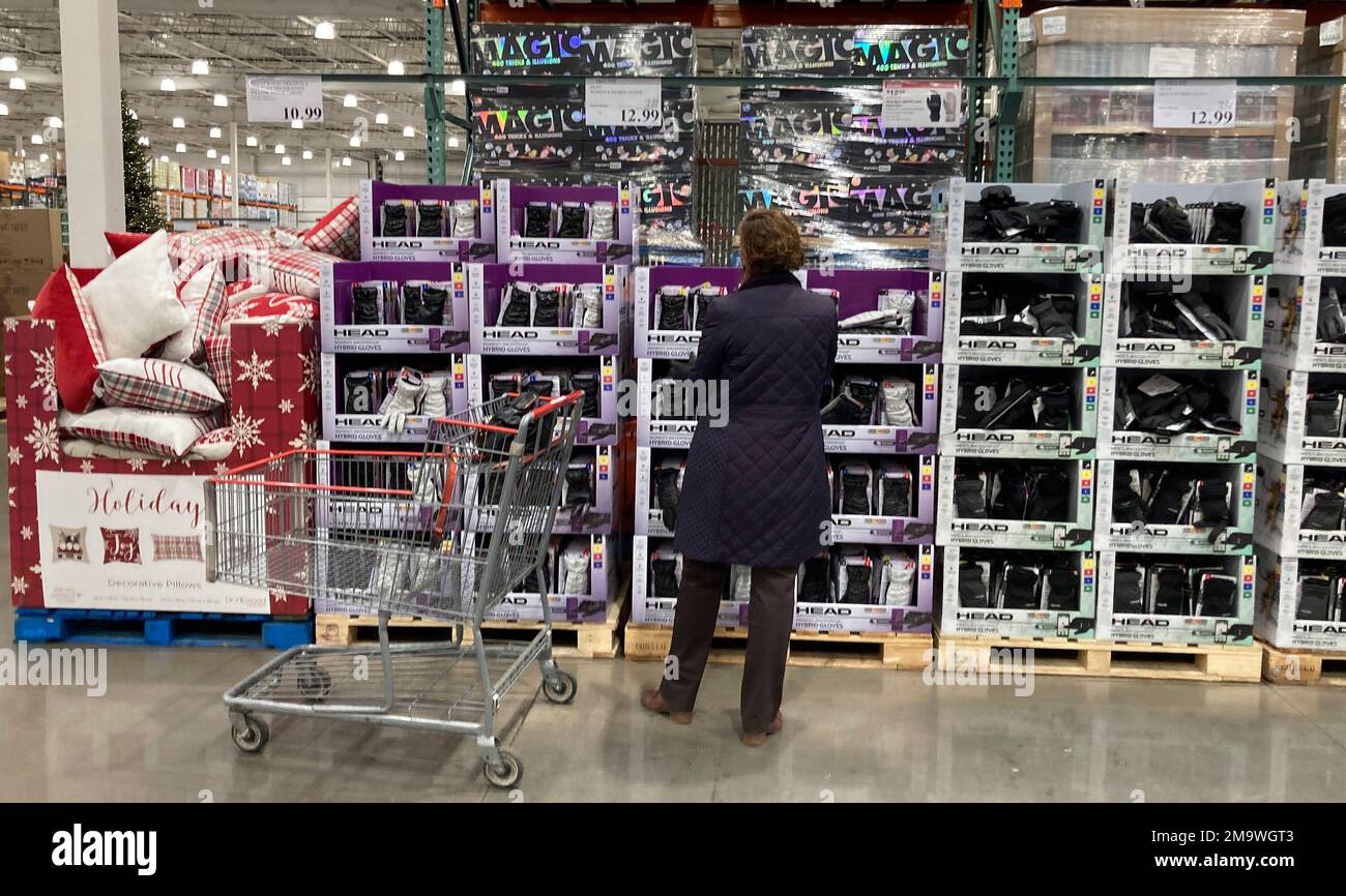 A shopper considers gloves placed in displays in a Costco warehouse lte ...