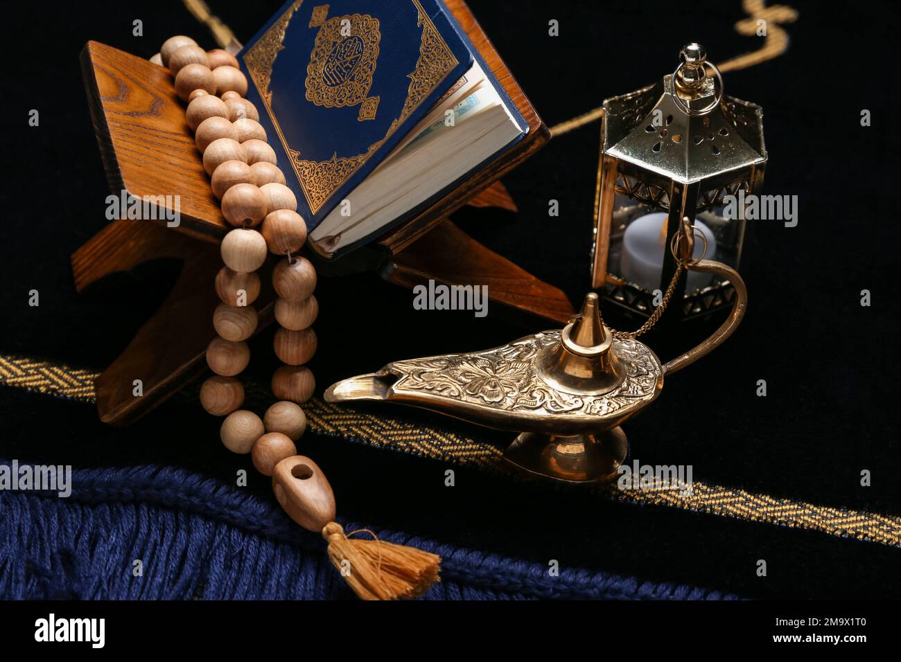 Aladdin lamp, Muslim lantern, Koran and prayer beads for Ramadan on mat,  closeup Stock Photo - Alamy