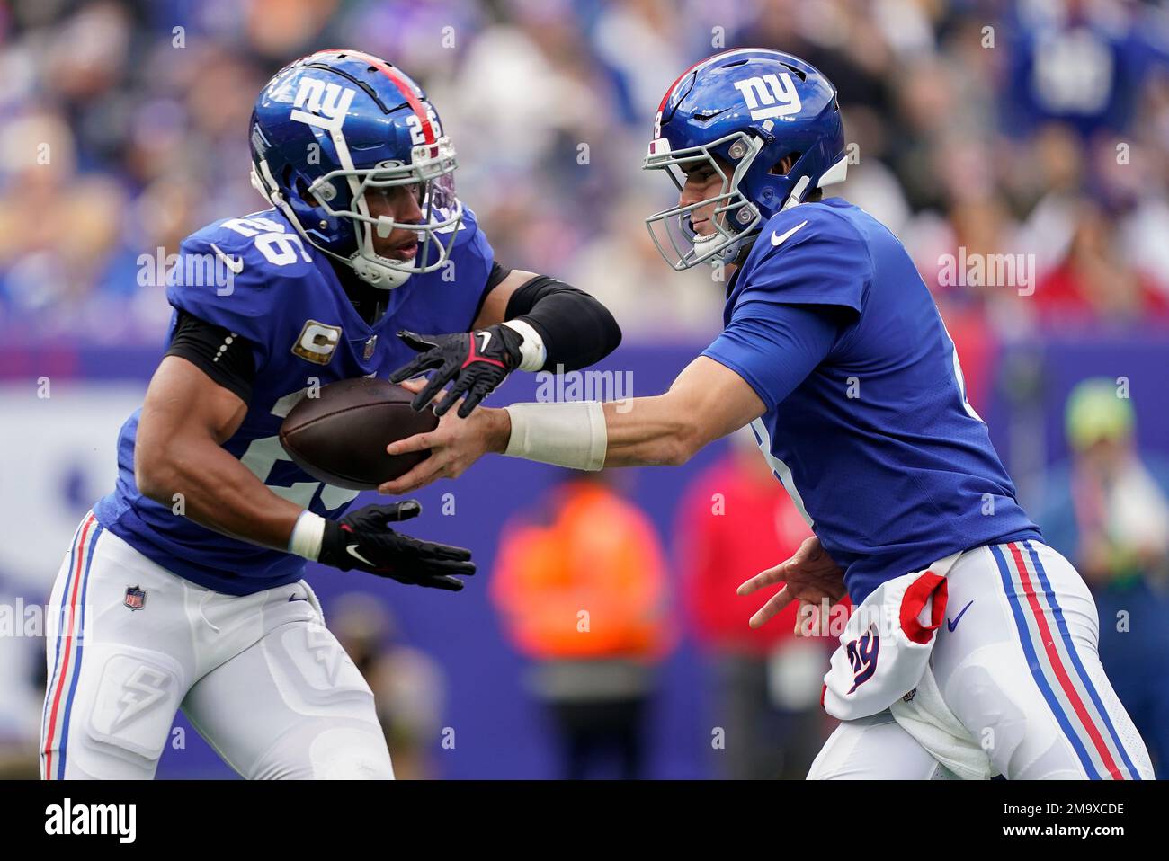 New York Giants quarterback Daniel Jones (8) hands off the ball to running back Saquon Barkley