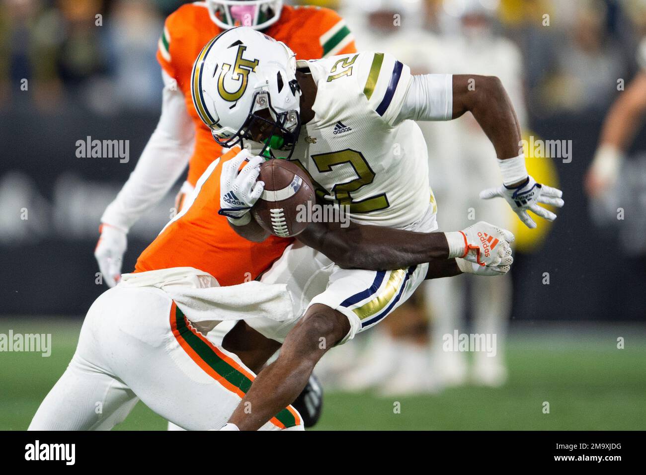 Miami cornerback DJ Ivey, left, hits Tech wide receiver Malik