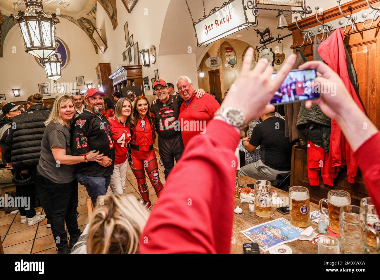 Fans pose for a photo with a Bucs cheerleader, during the Tampa Bay