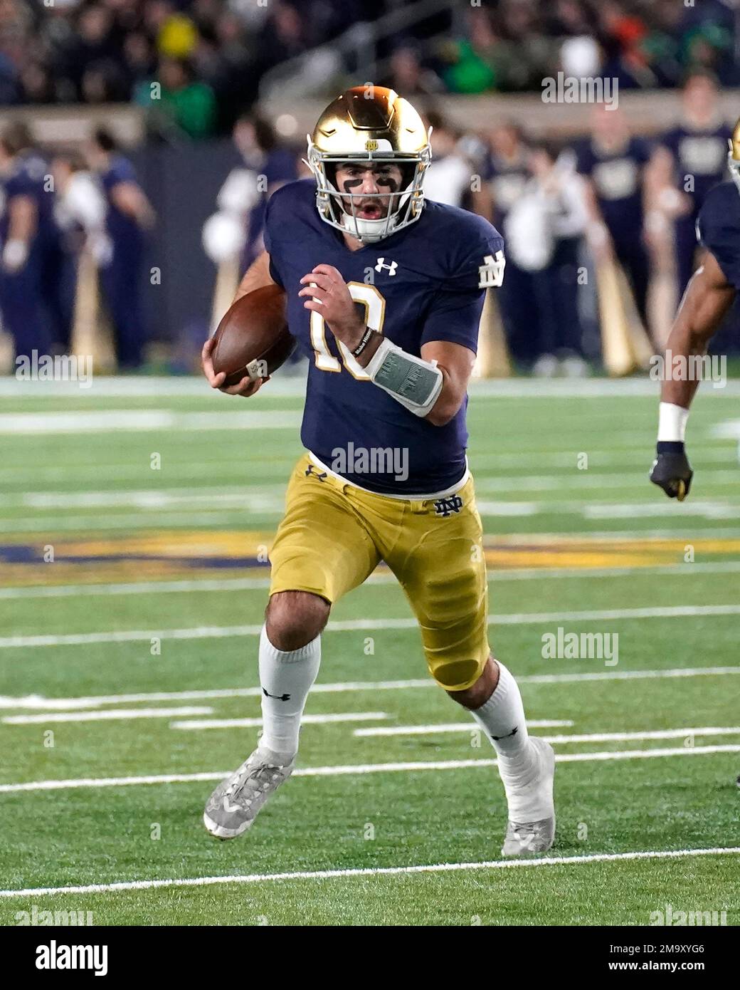 Notre Dame quarterback Drew Pyne carries the ball during an NCAA