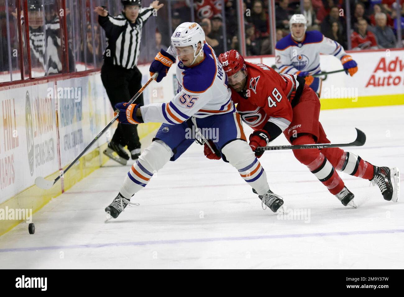 Edmonton Oilers left wing Dylan Holloway (55) attempts to hold back New  York Rangers center Ryan Carpenter (22) as players battle for the puck near  the Oilers' goal during the second period