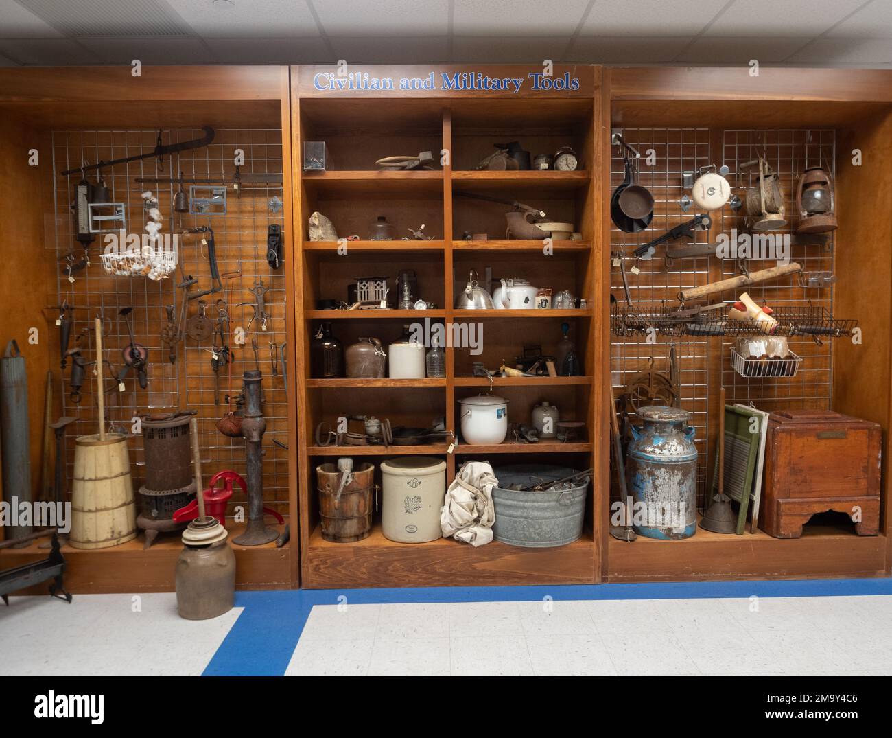 Display case with civilian and military tools and housewares on display