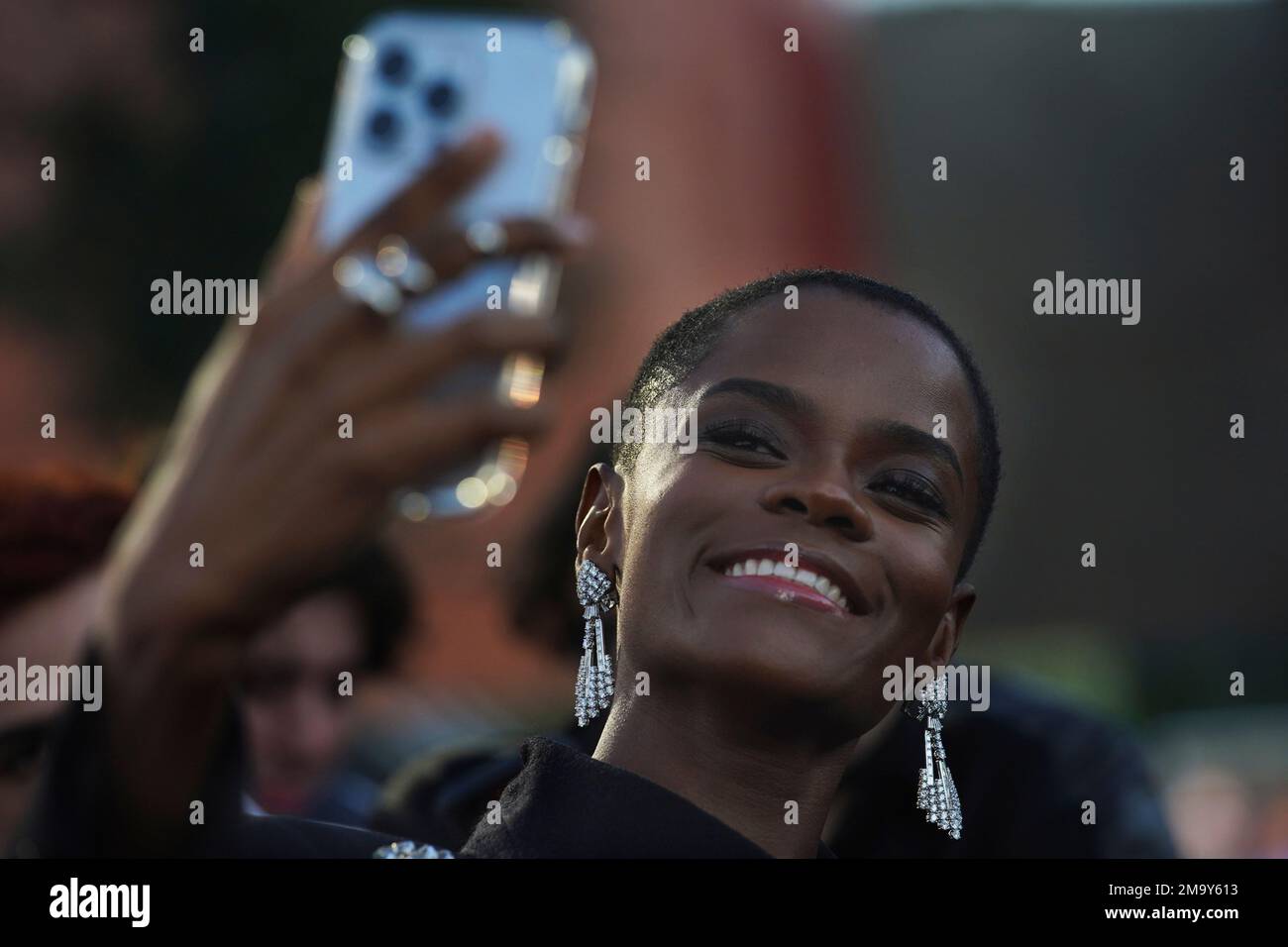 Actor Letitia Wright takes a selfie with a fan on the red carpet at the