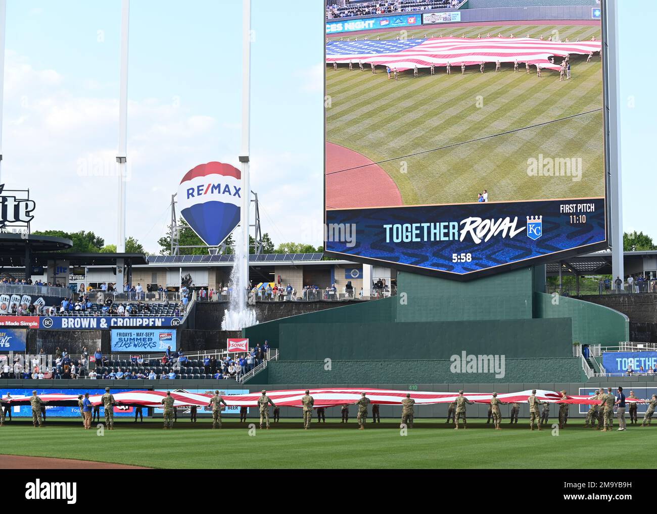Members of Team Whiteman hold a flag during Armed Forces Night at