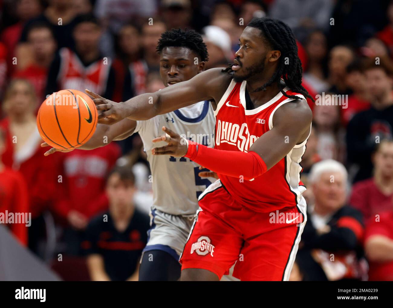 Ohio State guard Isaac Likekele, right, passes in front of Robert ...