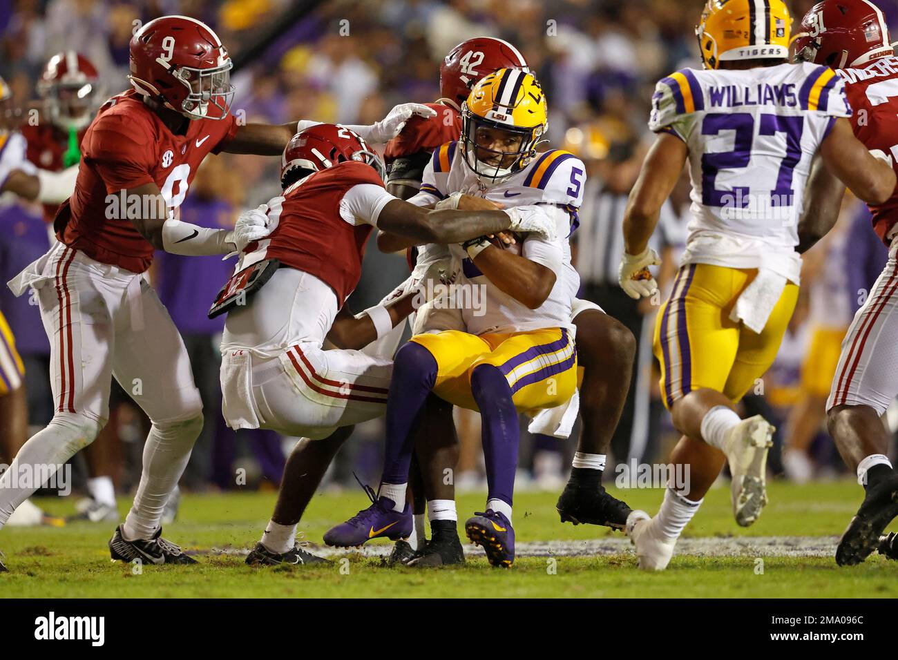 LSU quarterback Jayden Daniels (5) is tackled by Alabama linebacker