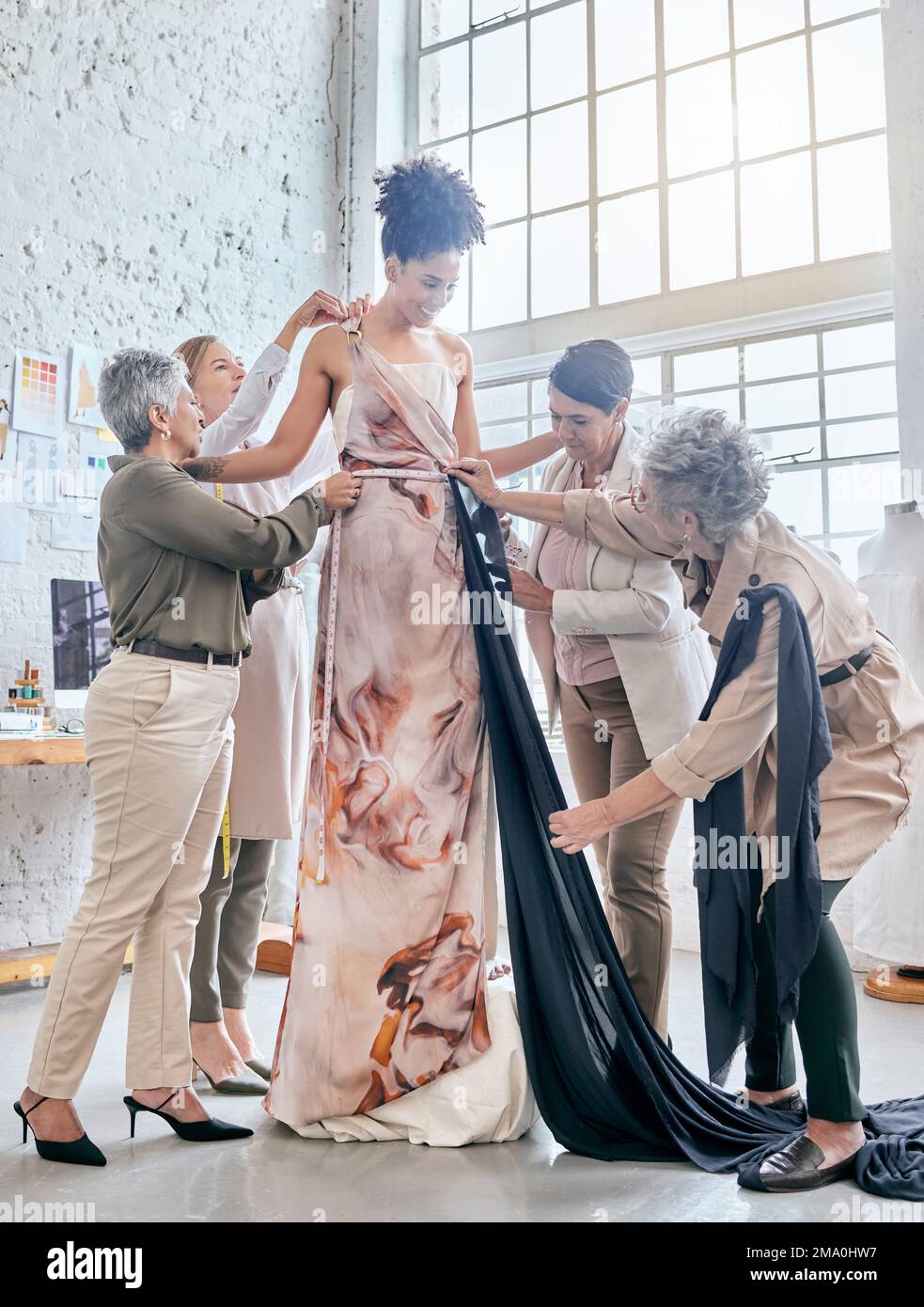 Designer women, help model and fitting dress, design and teamwork for runway fashion vision in workshop. Happy creative team, woman collaboration and Stock Photo