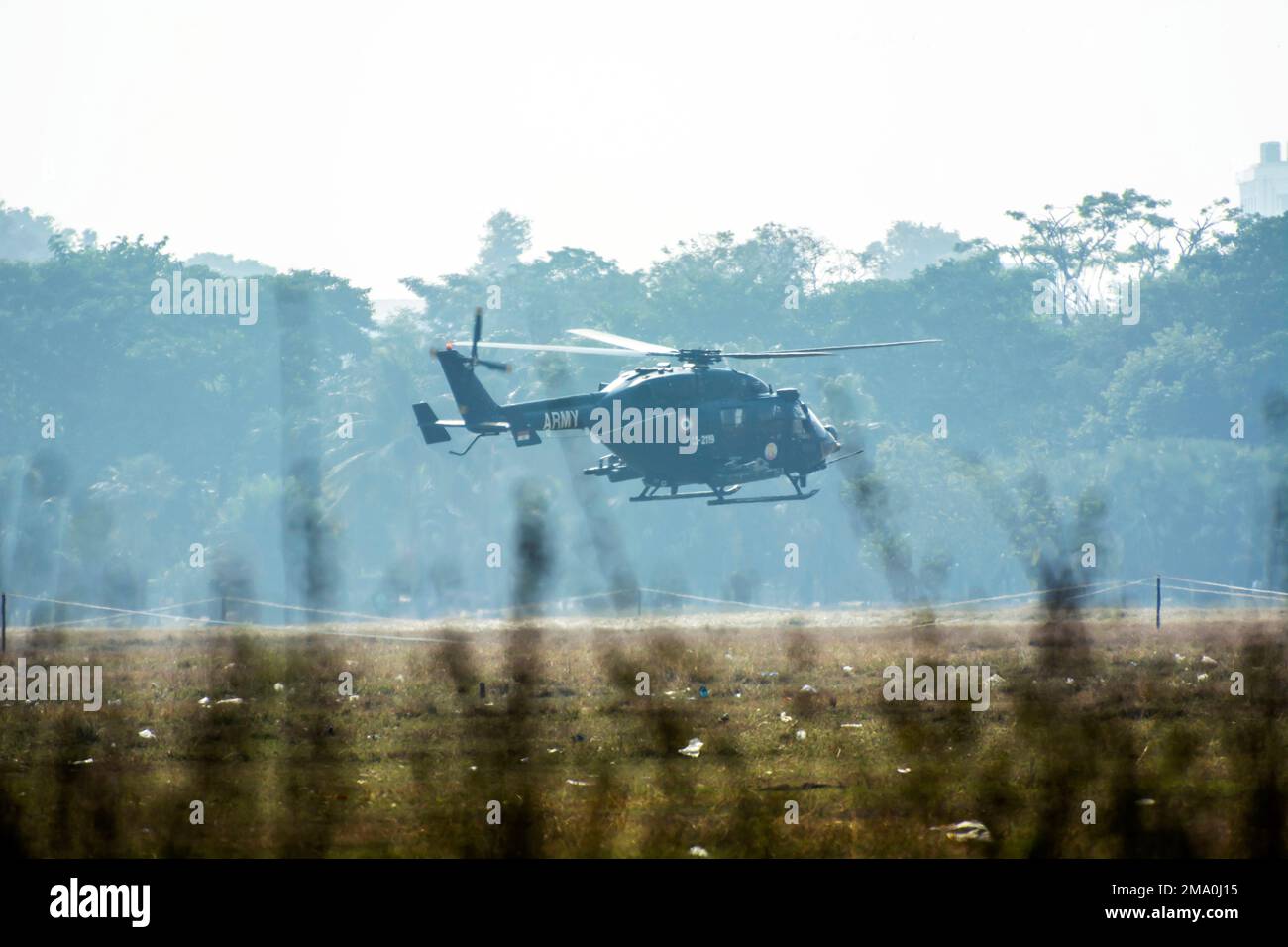 Helicopter take off from a paddy field in countryside in a dawn Stock Photo