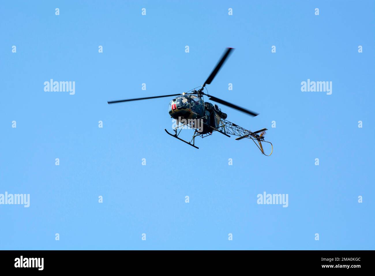 Calcutta, India - December 15, 2022: Close-up of flying chopper against isolated blue sky. Indian air force chopper. Stock Photo