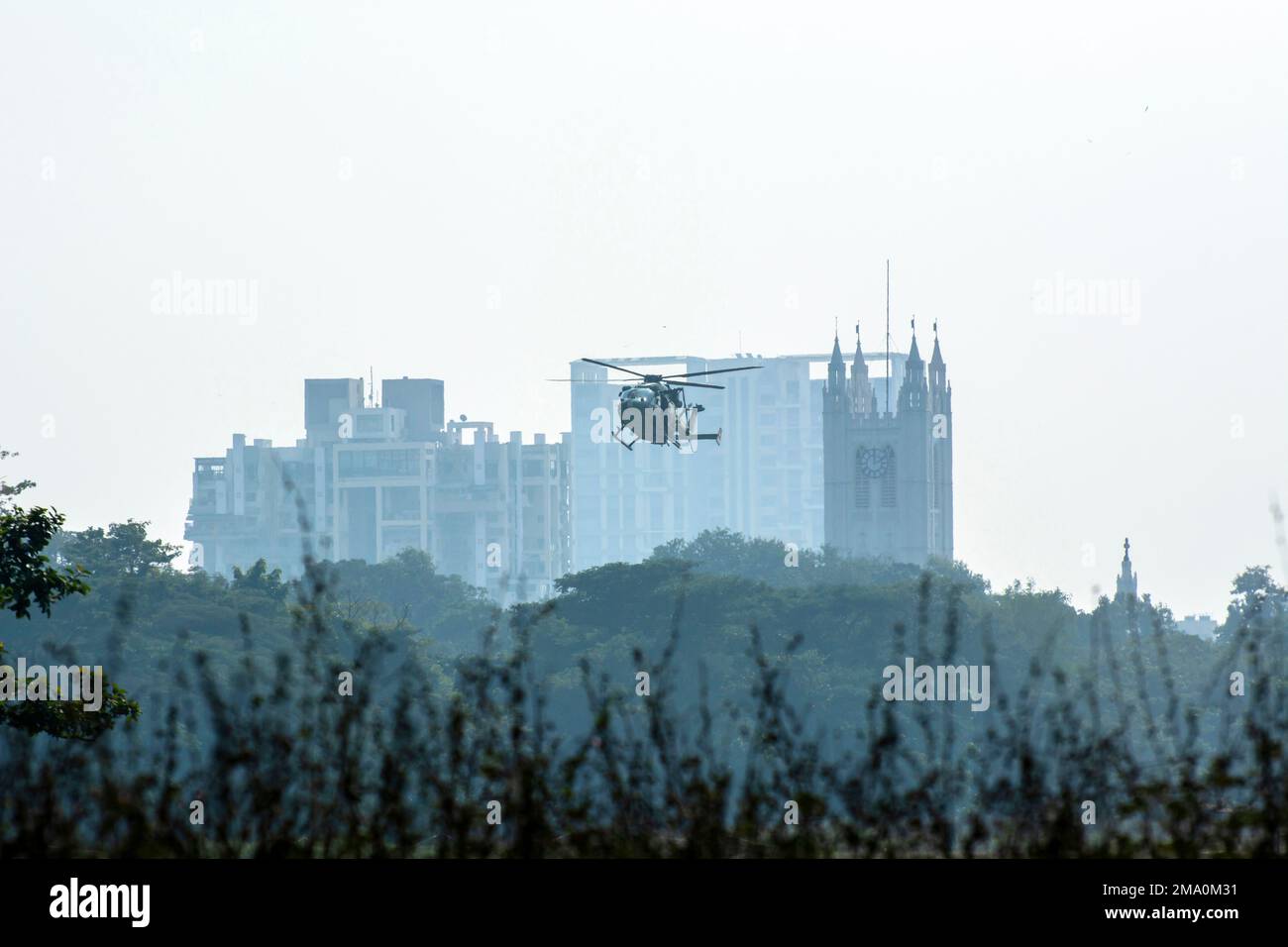 Helicopter take off from a paddy field in countryside in a dawn Stock Photo
