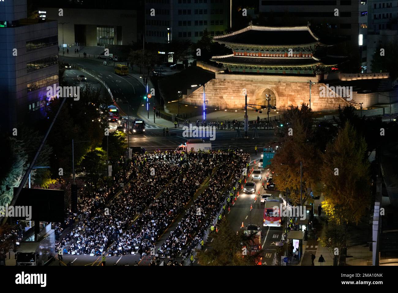 People attend a candlelight vigil for victims of Halloween crowd crush in Seoul, South Korea