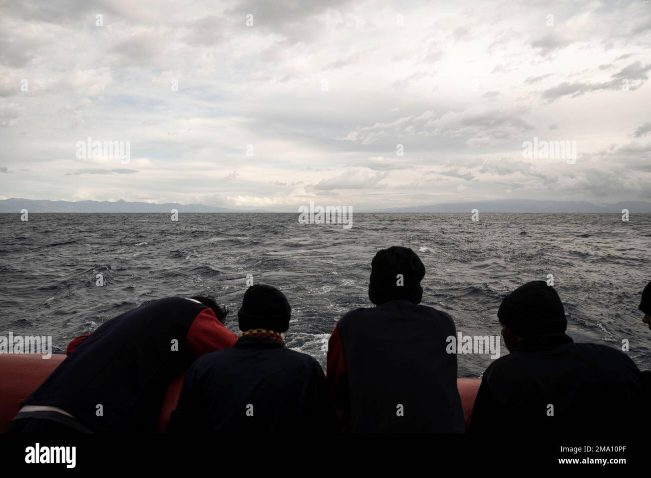 Migrants stand on the deck of the Ocean Viking rescue ship, in the ...