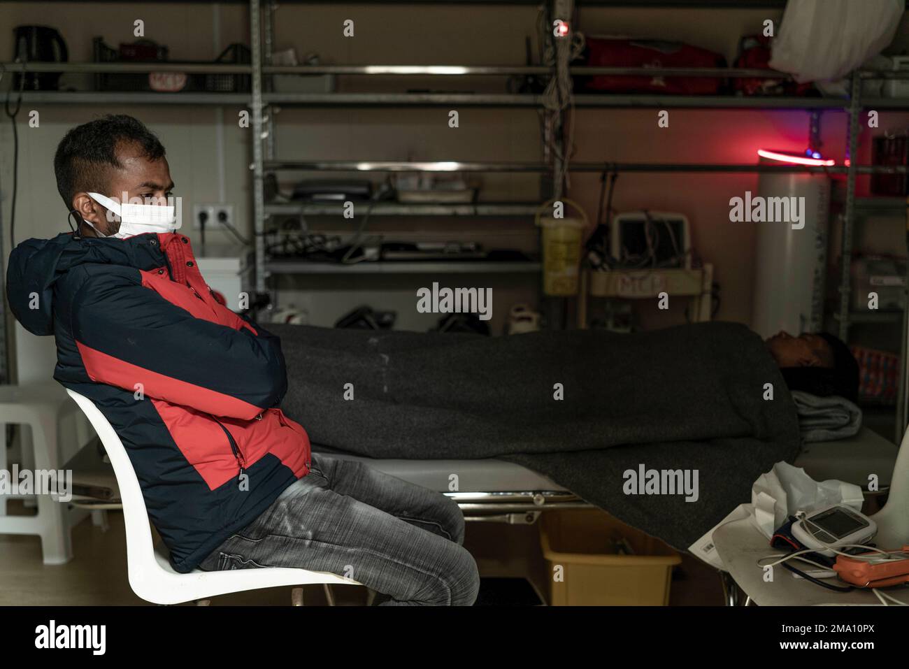 Migrants stand inside a facility of the Ocean Viking rescue ship, in ...
