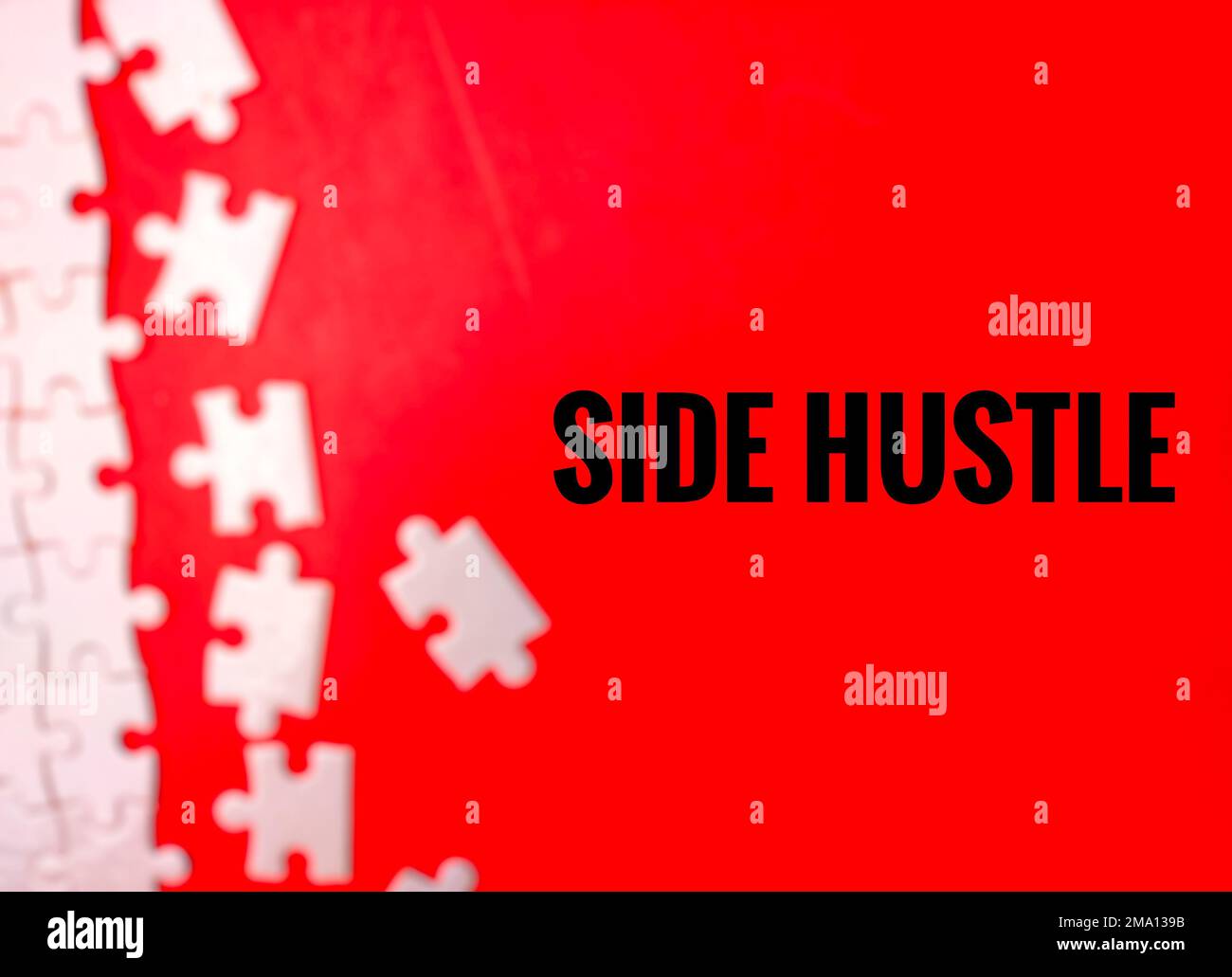 Blur Unfinished white jigsaw puzzle pieces on red background with the