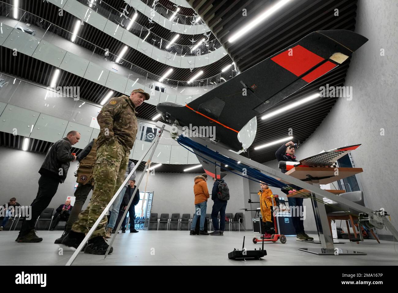 Visitors examine unmanned aerial vehicles in the 'PMC Wagner Centre', which is associated with businessman and founder of the Wagner private military group Yevgeny Prigozhin, during the official opening of the office block during National Unity Day, in St. Petersburg, Russia, Friday, Nov. 4, 2022. (AP Photo/Dmitri Lovetsky) Stock Photo