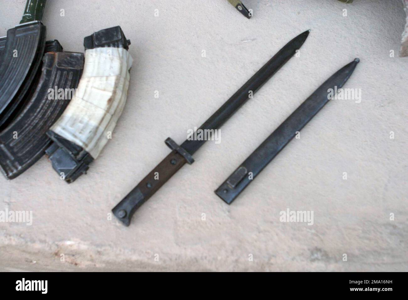 AK-47 magazines and a bayonet (not for AK-47) acquired by US Marine Corps (USMC) Marines from insurgents that attacked the police station in Al Kharma, Iraq, during Security and Stabilization Operations (SASO) in the Al Anbar Province in support of Operation IRAQI FREEDOM. Base: Al Shahabi State: Al Anbar Country: Iraq (IRQ) Stock Photo