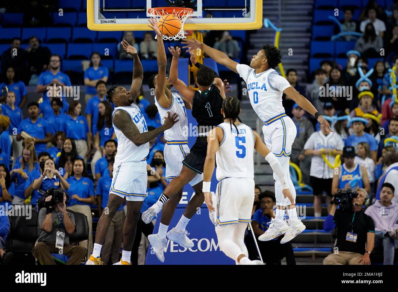 Concordia University Irvine guard Kobe Sanders (1) is defended by UCLA  forward Kenneth Nwuba (14), guard Abramo Canka (1) and guard Jaylen Clark  (0) during the second half of a college basketball