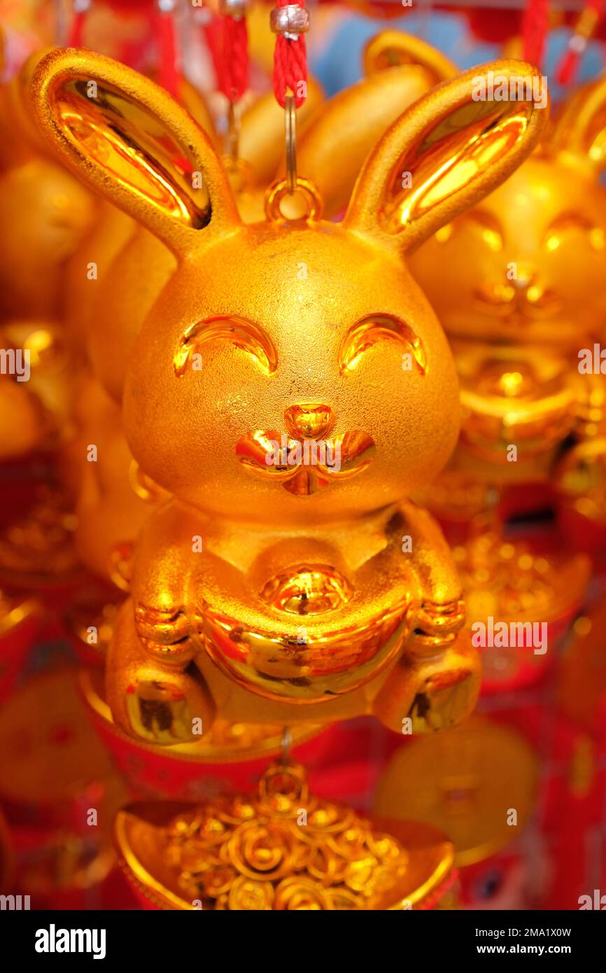 Close-up of a Golden Rabbit trinket holding an ingot, for sale at a ...