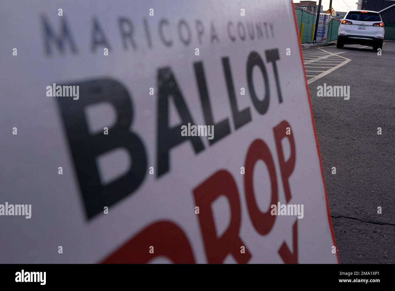 A voter casts their ballot at a secure ballot drop box at the Maricopa