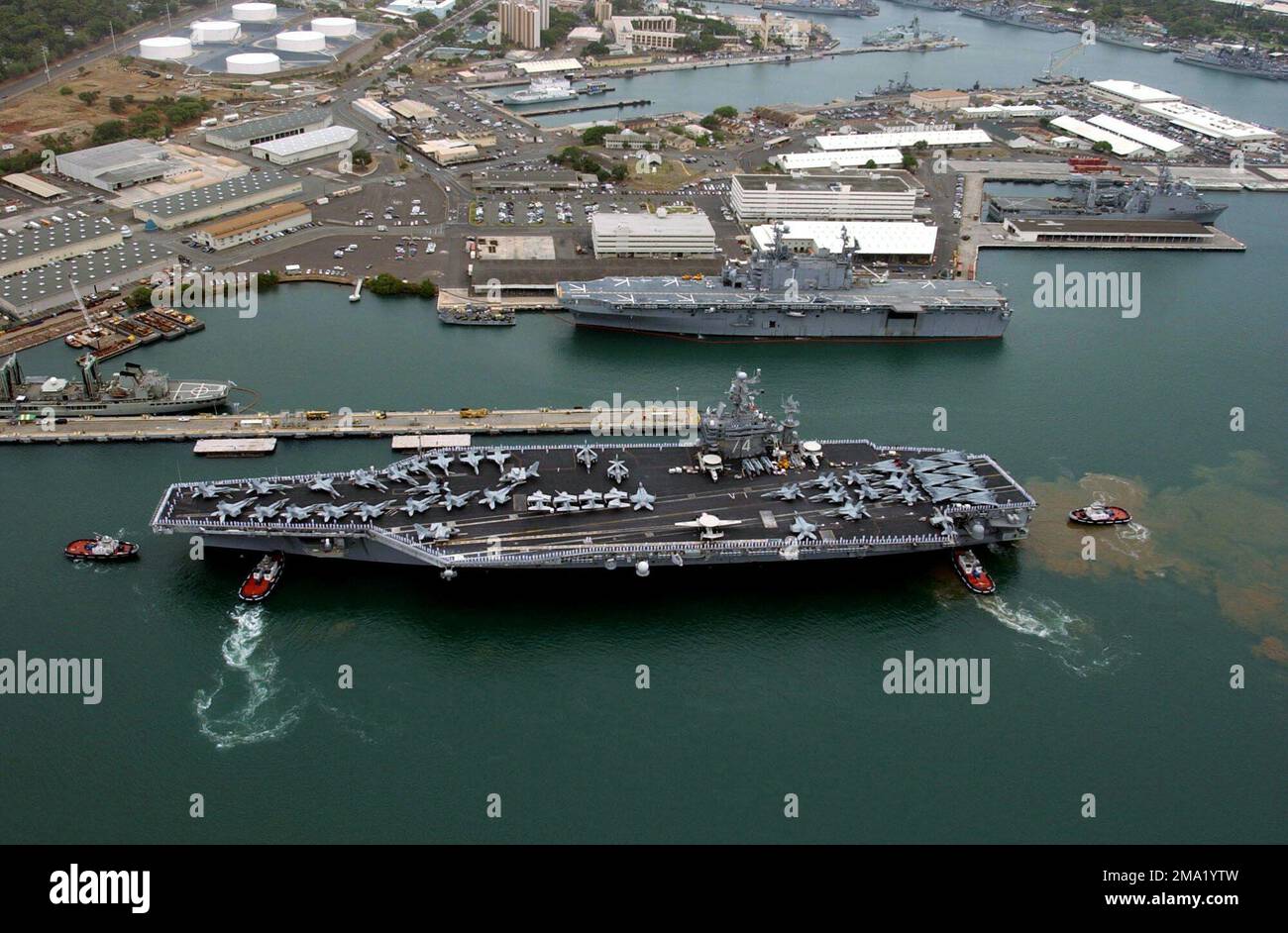 040629-N-7498B-052. [Complete] Scene Caption: Several tugboats assist ...
