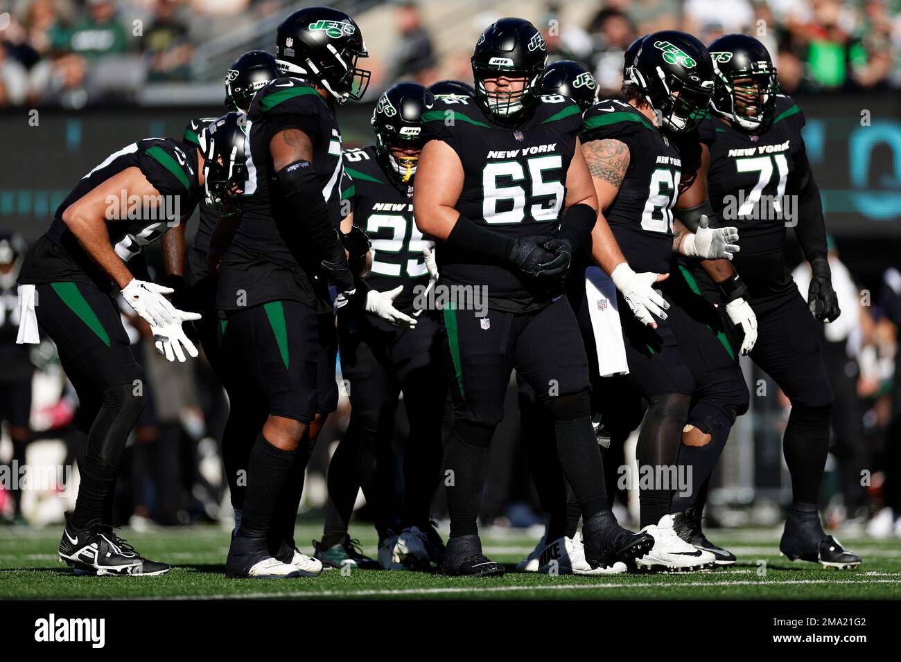 New York Jets guard Nate Herbig (65) walks to the line of scrimmage against  the New England Patriots during an NFL football game Sunday, Oct. 30, 2022,  in East Rutherford, N.J. (AP