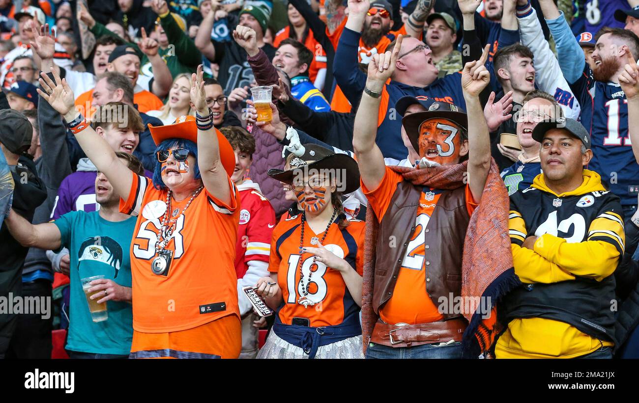 Fans sing "Sweet Caroline" during an NFL football game between the