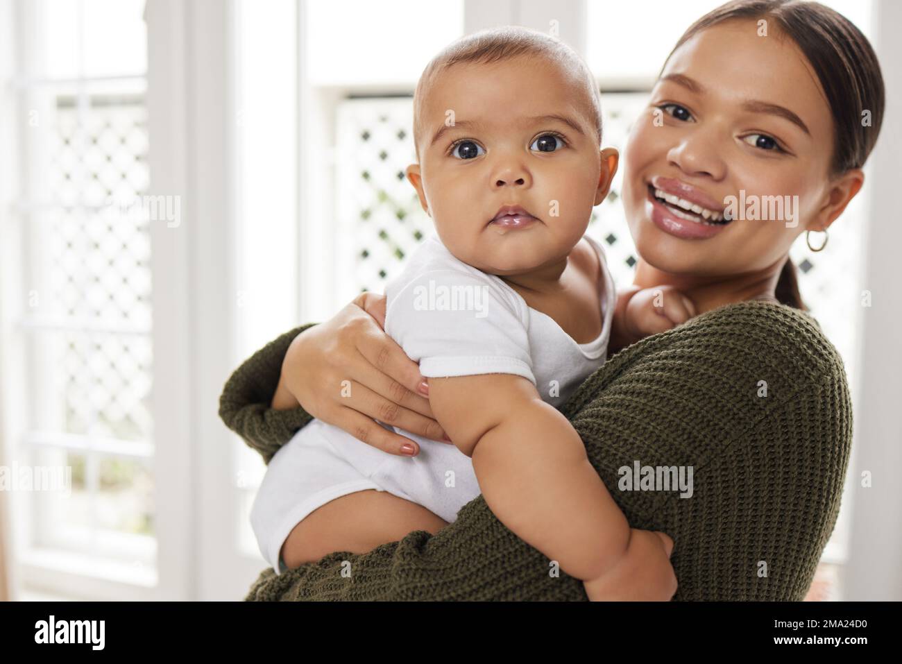 Baby boys have a pocket full of mischief. a young mother holding her baby. Stock Photo
