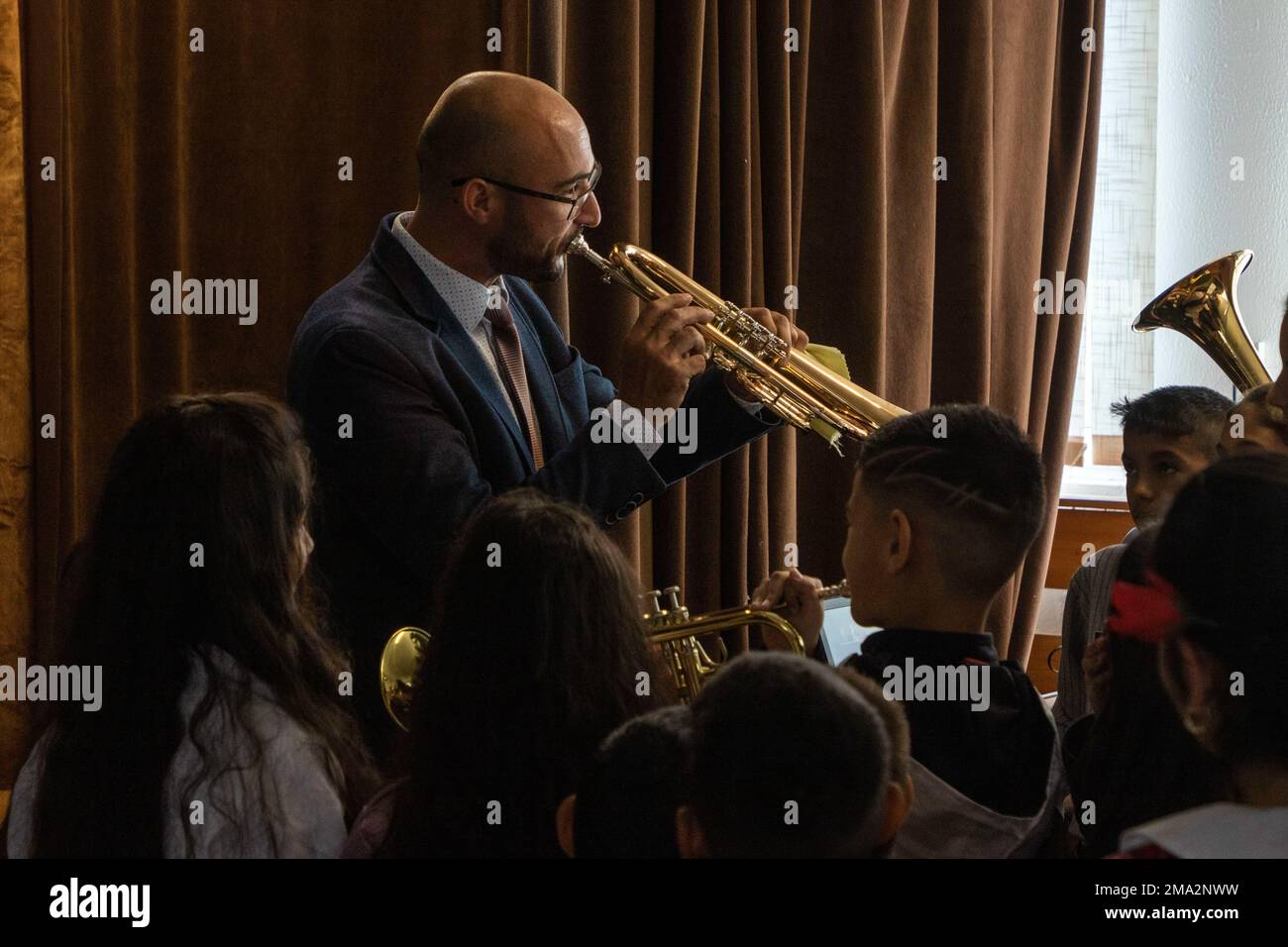 Denis Gonsalvesh, deputy mayor of Nessebar for Public Order, Youth Activities and Sport,  plays the flugelhorn to demonstrate how to play brass instruments and to help foster an appreciation of music and fine arts for the students attending Georgi Rakovski Primary School in Orizare, Bulgaria, May 23, 2022. Georgi Rakovski Primary School is constantly renewing and modernizing while remaining a methodological center where children are educated in a modern environment combining innovative and traditional methods. Bulgaria is a steadfast and gracious host to its partners and allies, and the U.S. i Stock Photo