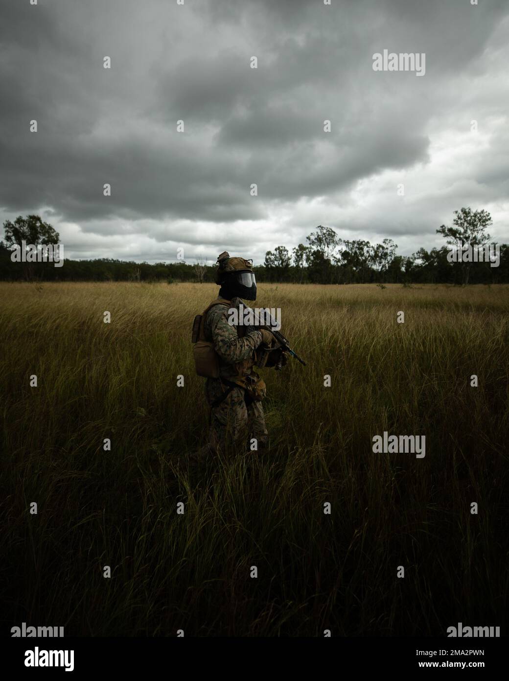 U.S. Marine Corps Sgt. Terrance Jones, a joint terminal attack controller, with Lima Company, 3d Battalion, 7th Marine Regiment, Ground Combat Element, Marine Rotational Force-Darwin 22, patrols during a less-than-lethal training exercise as part of exercise Southern Jackaroo 22 at Shoalwater Bay Training Area, Queensland, Australia May 24, 2022. The less-than-lethal training involved a combat scenario using simunition rounds and transitioned to a mass casualty scenario where the injured role-players were assessed, treated and then transported to a higher echelon of care. Stock Photo