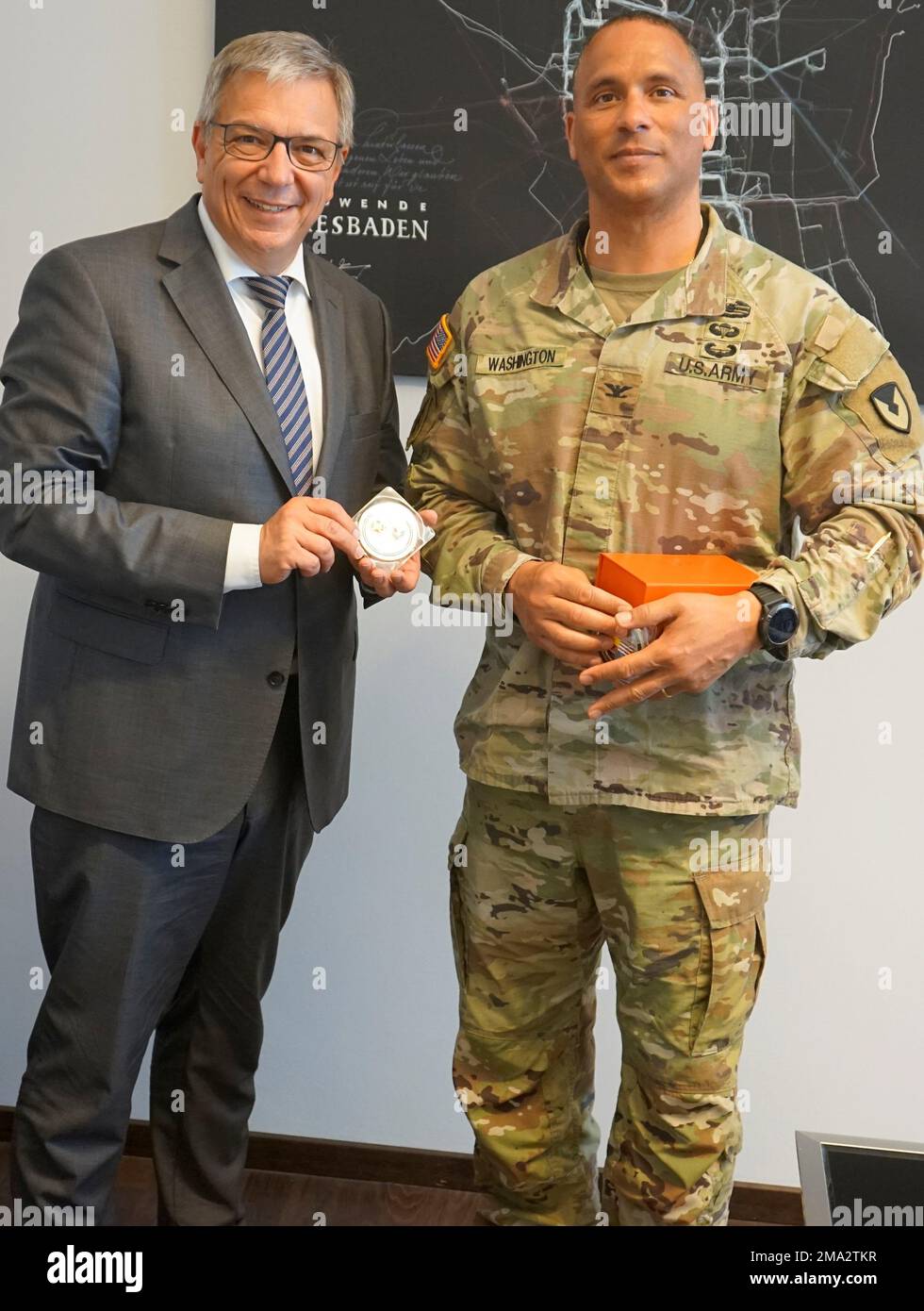 WIESBADEN, Germany -- Lord Mayor of Wiesbaden, Gert-Uwe Mende, thanked Colonel Mario A. Washington with a little piece of “Sinter” in memory to the 65 Celsius hot spring in Wiesbaden on 24 May 2022. (Reference U.S. Army Garrison Wiesbaden Roland Schedel) Stock Photo