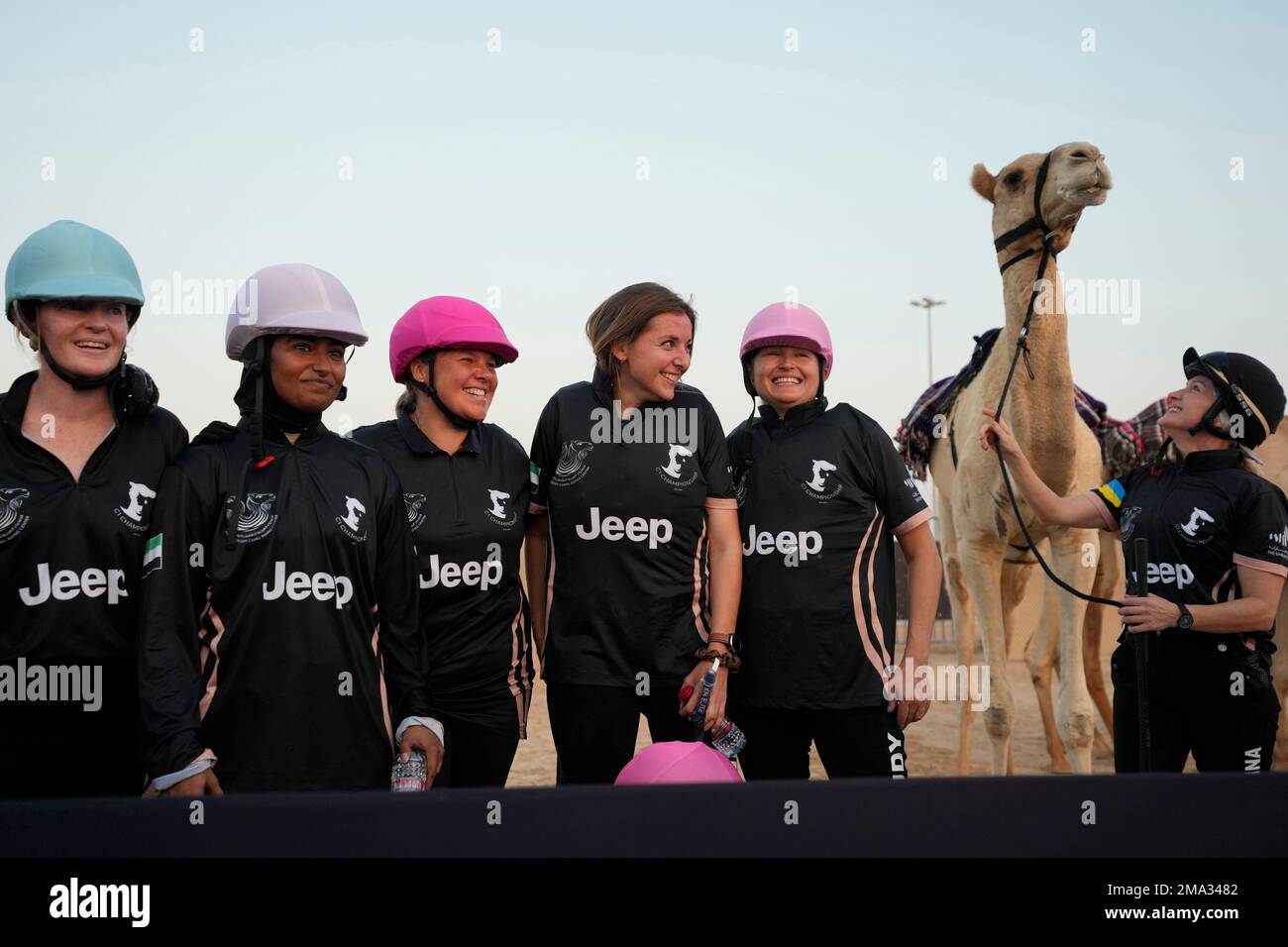 Women camel riders pose after they compete at the first race of the ...