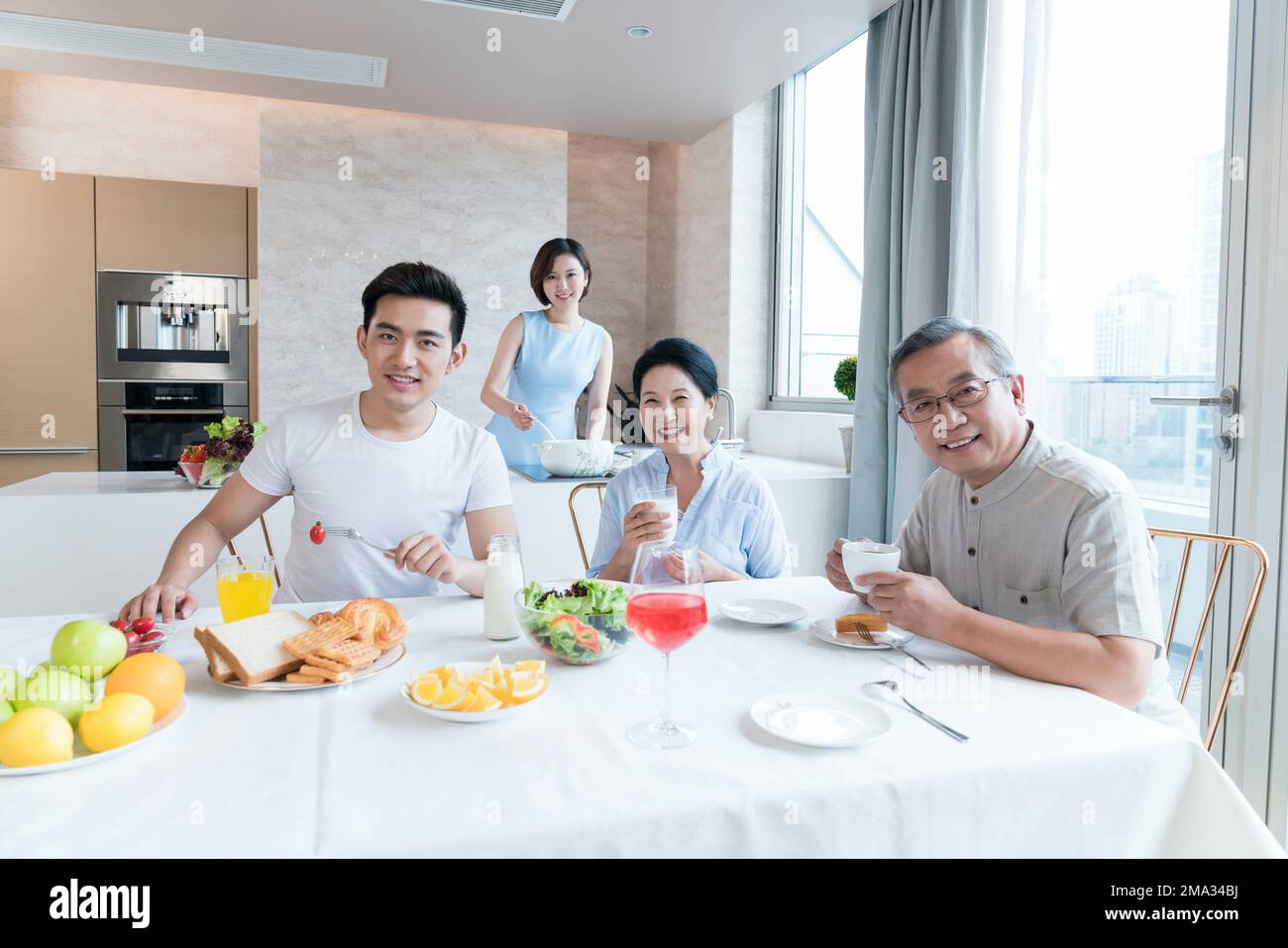 Happy family in the kitchen to have breakfast Stock Photo