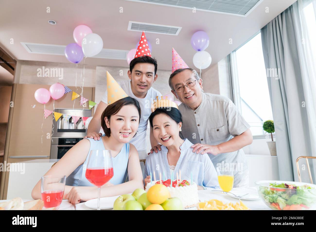 Happy family party to celebrate in the kitchen Stock Photo