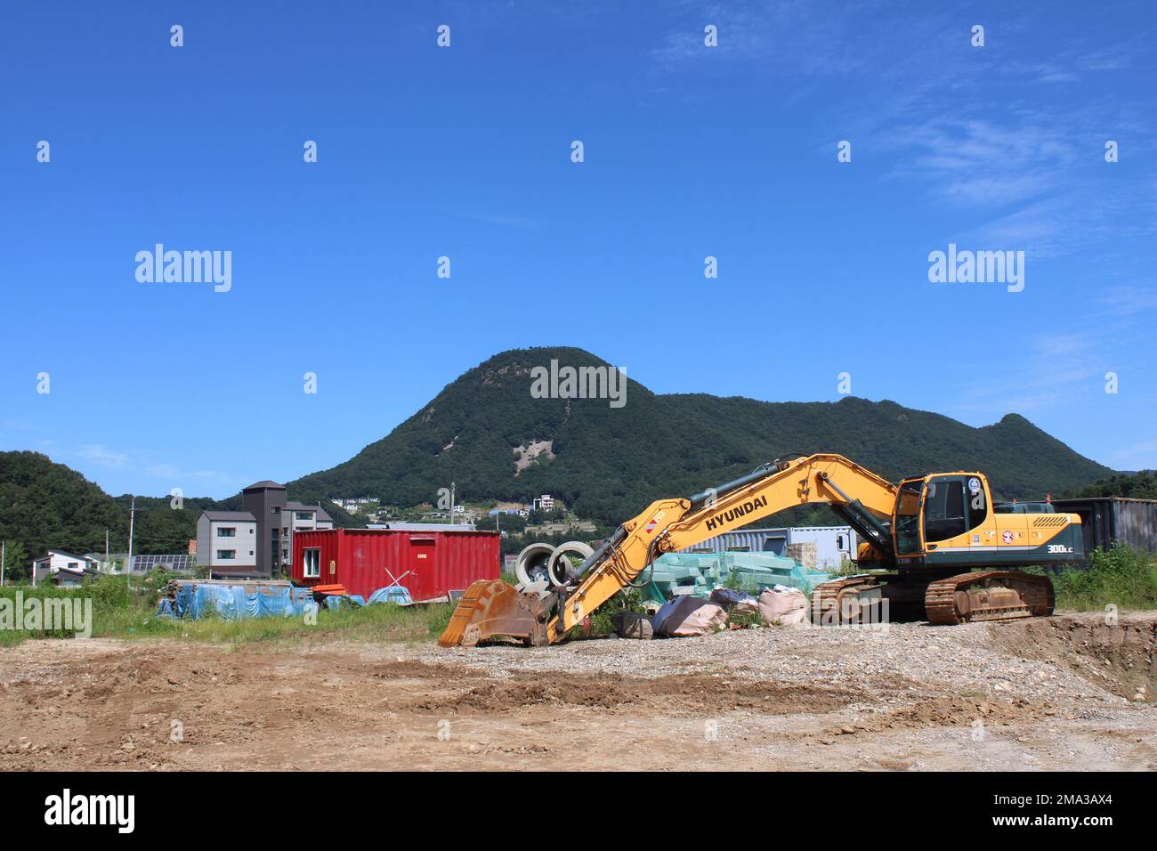 Yellow Hyundai excavator in rural construction site Stock Photo