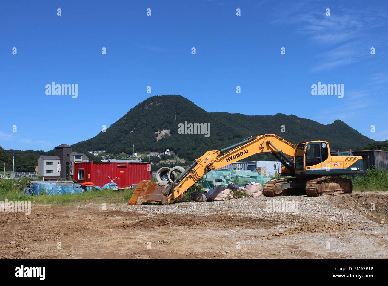 Yellow Hyundai excavator in rural construction site Stock Photo - Alamy