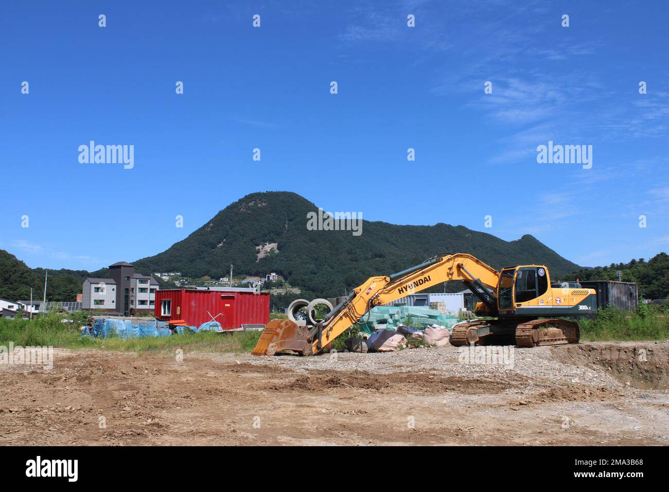 Yellow Hyundai excavator in rural construction site Stock Photo
