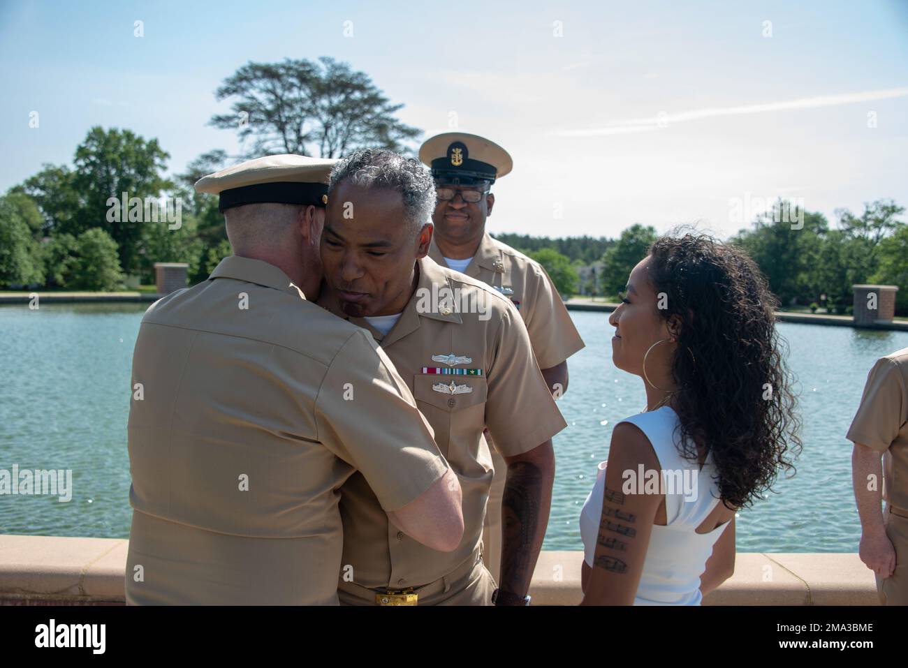 220523-N-XK809-1075 FORT MEADE, Md. (May 23, 2022) Master Chief Information Systems Technician Amaury Ponciano, from Union City, N.J., assigned to U.S. Fleet Cyber Command/U.S. 10th Fleet, is pinned to his current rank during a pinning ceremony at the fountain by the Fort Meade Parade Field. Stock Photo