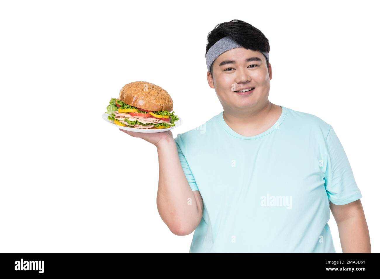 Fat young man holding a burger Stock Photo