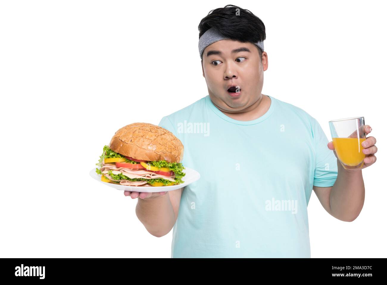 Fat young man holding a hamburger and drinks Stock Photo