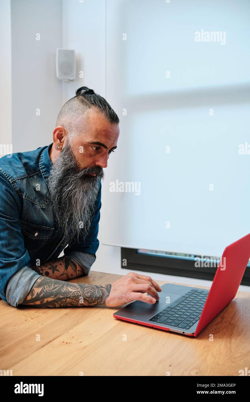 Man using a laptop while working in the office. Stock Photo