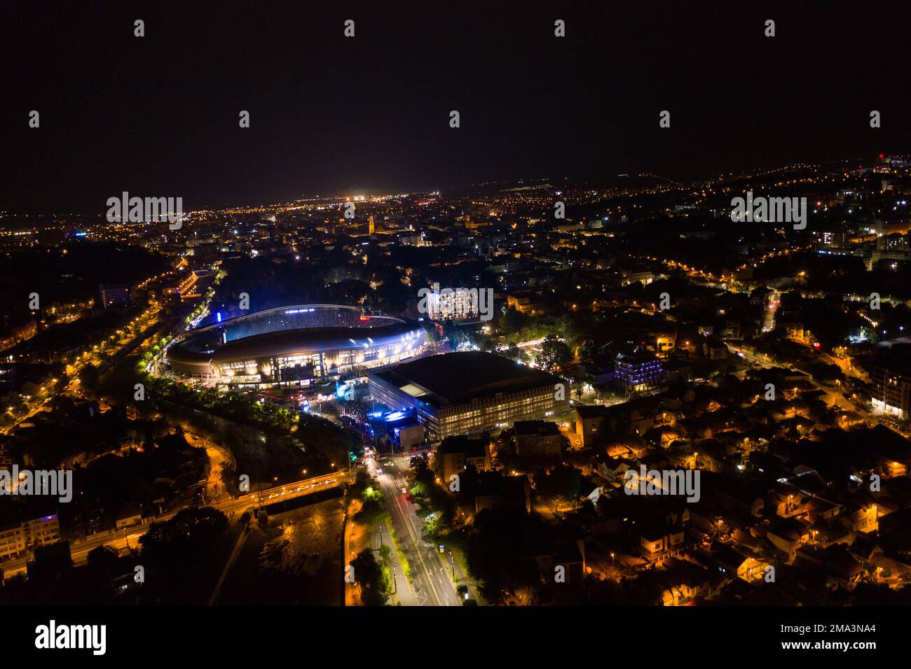 Aerial view of Cluj Napoca city by night. Urban landscape with illuminated streets, Romania Stock Photo
