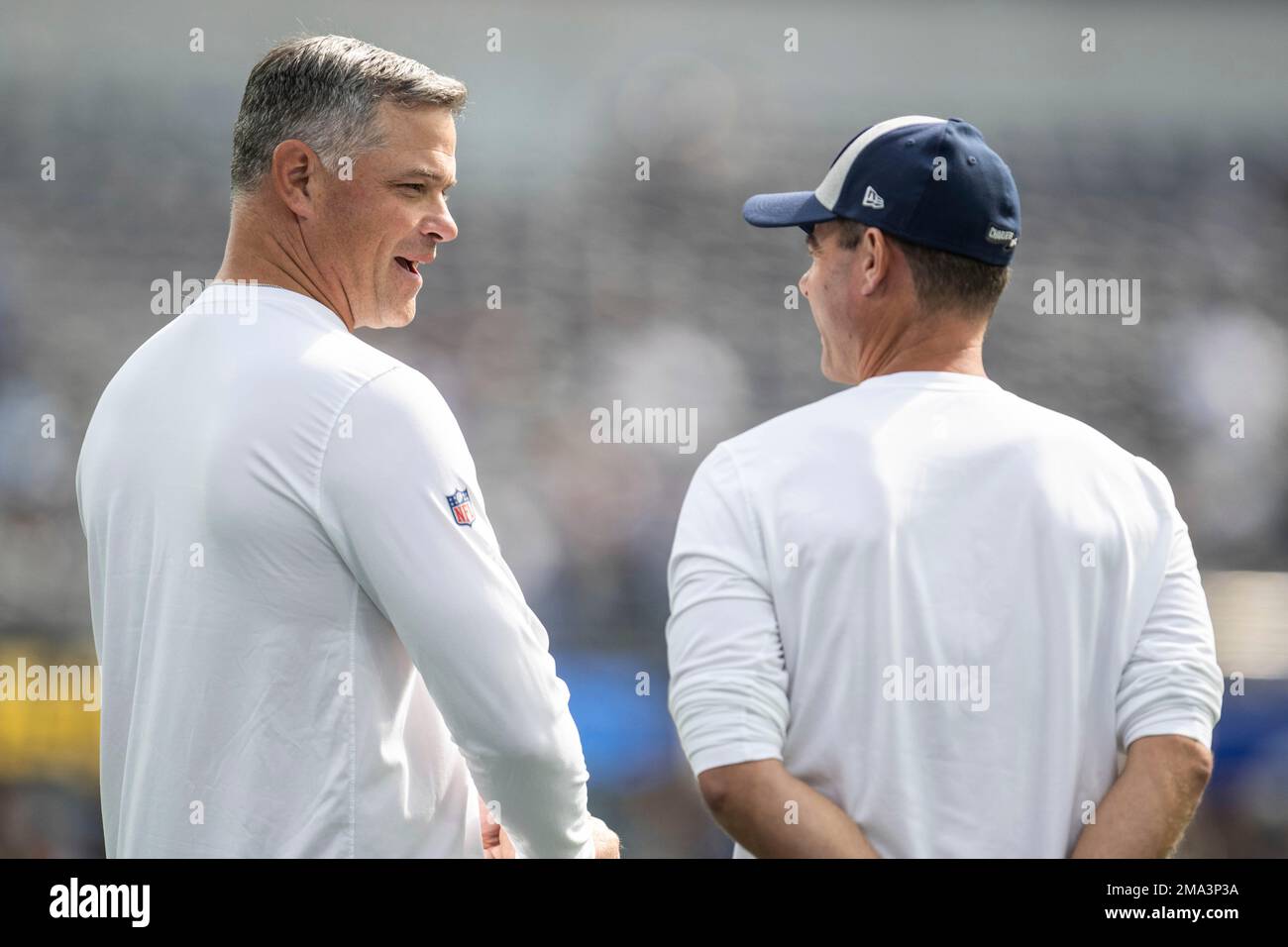 Los Angeles Chargers offensive coordinator Joe Lombardi, left, talks to  head coach Brandon Staley before an NFL football game against the Seattle  Seahawks, Sunday, Oct. 23, 2022, in Inglewood, Calif. (AP Photo/Kyusung