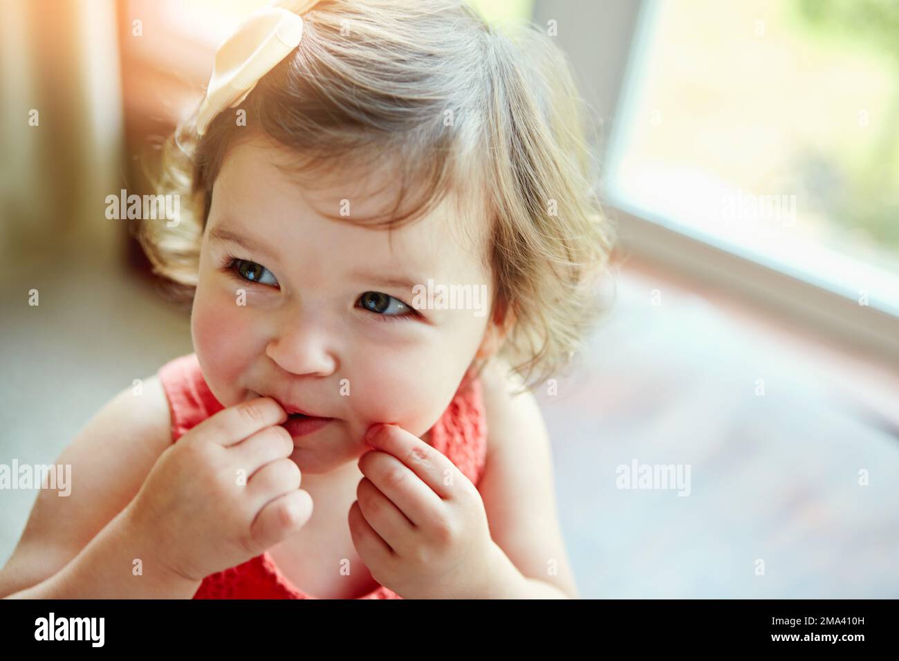 Happy, baby and girl playing in her home, looking, taste and curious