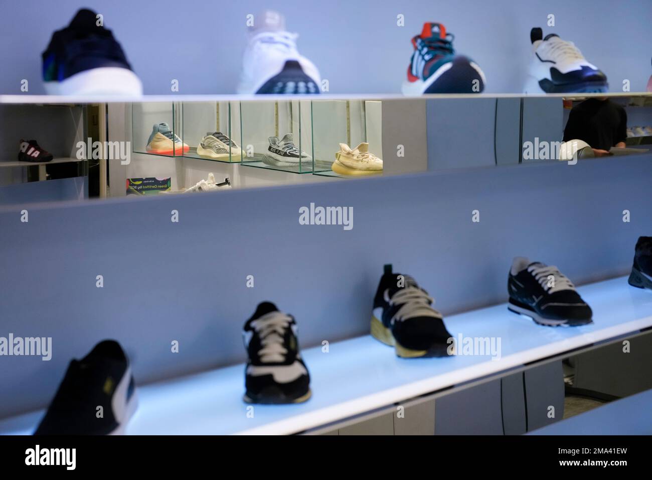Yeezy shoes made by Adidas displayed inside cases are reflected in a mirror other shoes, at Addict shoe in Brickell City Center in Miami, Tuesday, Oct. 25, 2022. (AP Photo/Rebecca